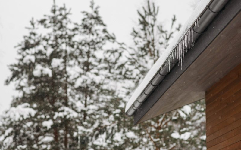 Ice dams and clogged gutters on home.