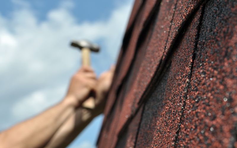 Person repairing a roof.